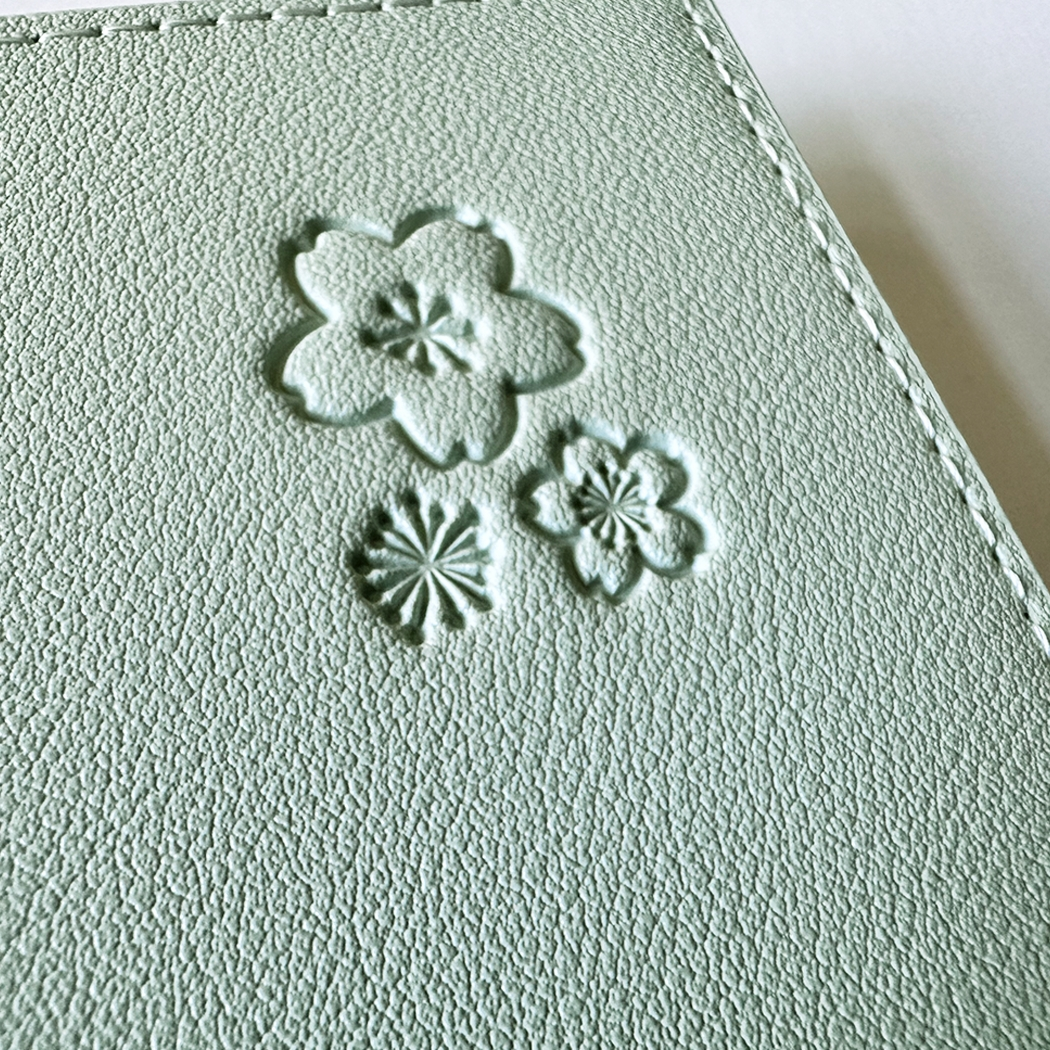 SAKURA journal for girls in stylish fashion colors, high-quality paper, compact and easy to carry, with elastic band and brass floral pendant. By Victoria's Journals. green