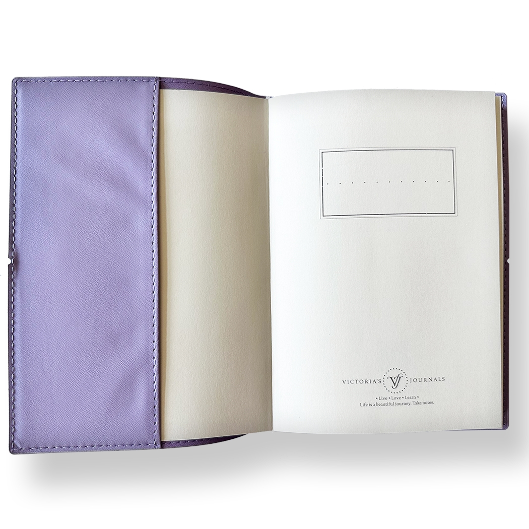 SAKURA journal for girls in stylish fashion colors, high-quality paper, compact and easy to carry, with elastic band and brass floral pendant. By Victoria's Journals. Lilac